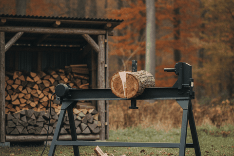 electric log splitter on a steel stand with a round on the beam mid split