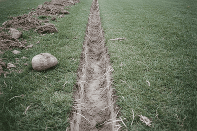 A narrow trench chopped straight through matted sod into the subsoil. Grub Hoe: What It Is For and the 3 Best Ones