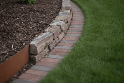 garden bed edge in three materials meeting