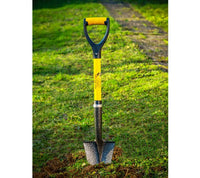 Spear Head Spade SHMini standing in a lawn, blade pushed into the soil