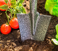 Spear Head Spade SHMini spearhead blade in garden soil beside ripe tomatoes