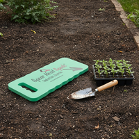 Spear Head Spade garden kneeler on a path beside seedlings and a trowel