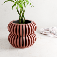 Orchid Double Bubbles Planter in Terracotta holding a plant in a nursery pot