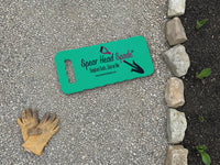 Spear Head Spade garden kneeler on a gravel path beside a stone border, with garden gloves